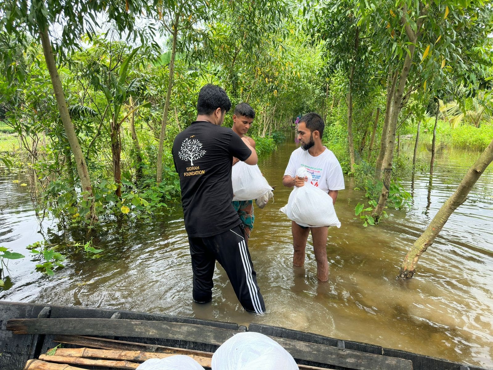 Sidrah Foundation support being carried through a flood-affected community